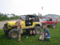 Dave Stauffer & Janet Nutter watching John Nutter fix his CJ-7 fuel pump