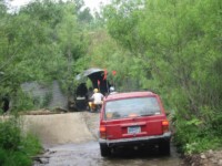 Jerry following ATVs through a culvert
